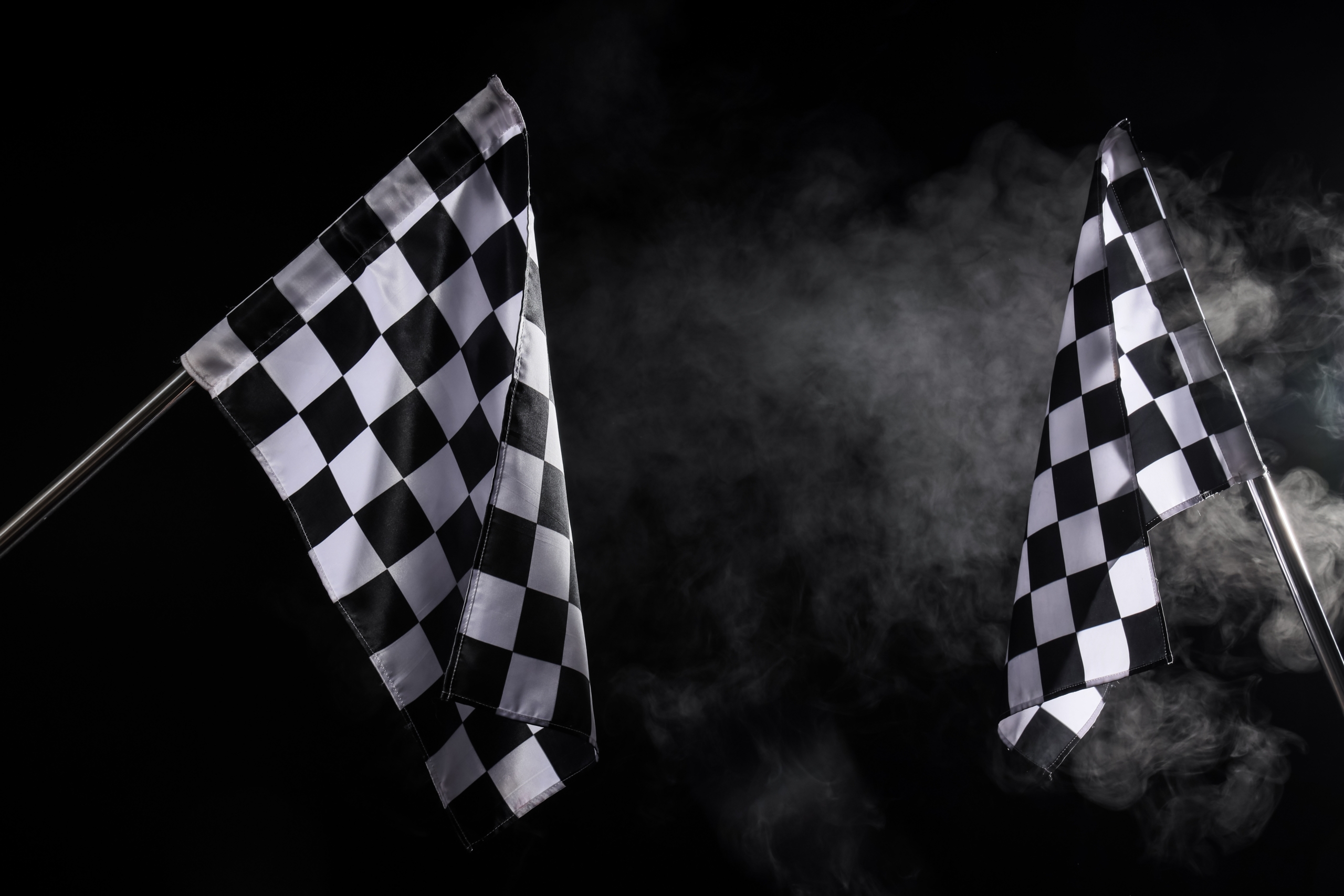 Racing,Flags,And,Smoke,On,Black,Background